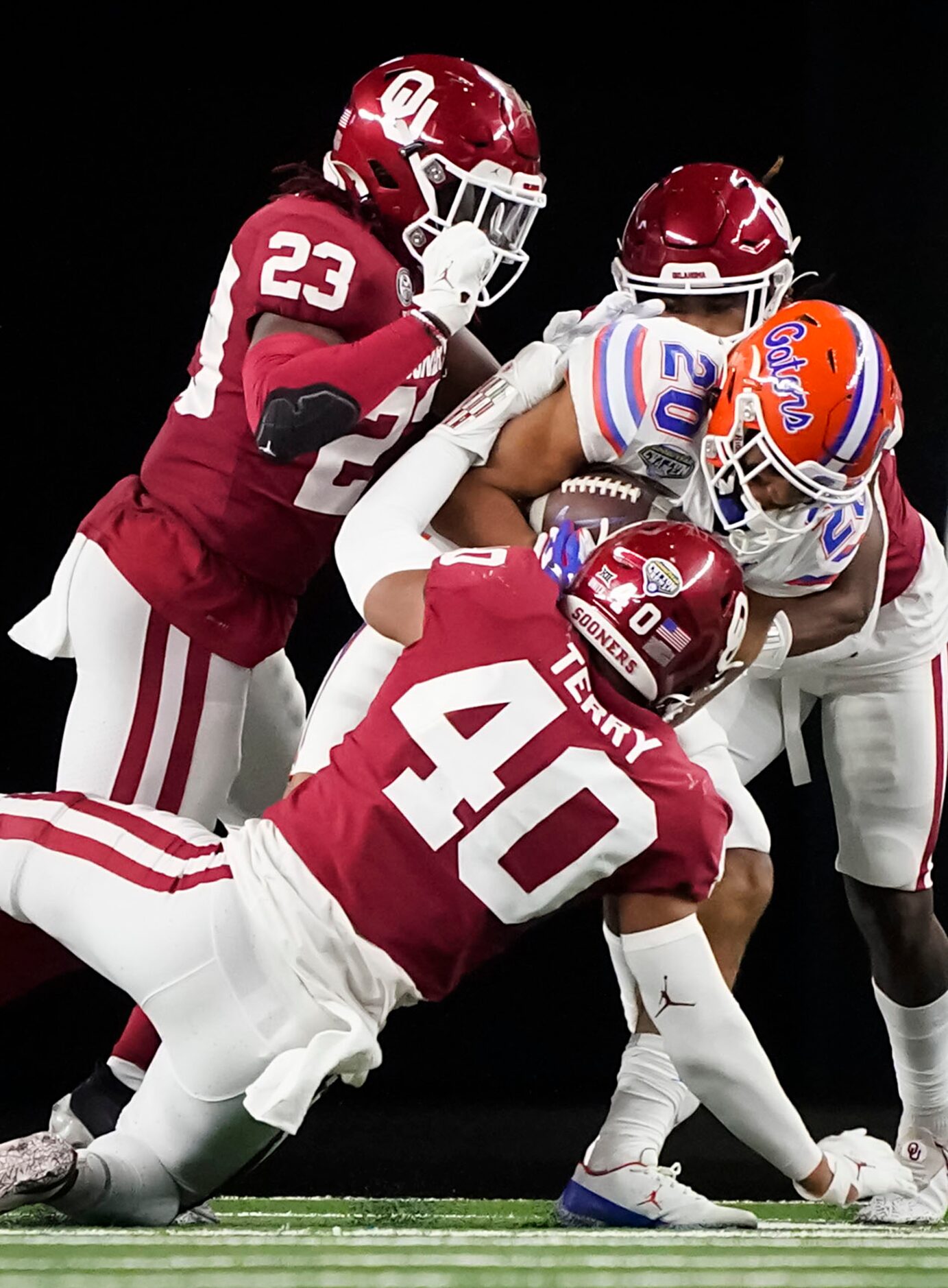 Florida running back Malik Davis (20) is brought down by Oklahoma linebacker Jon-Michael...