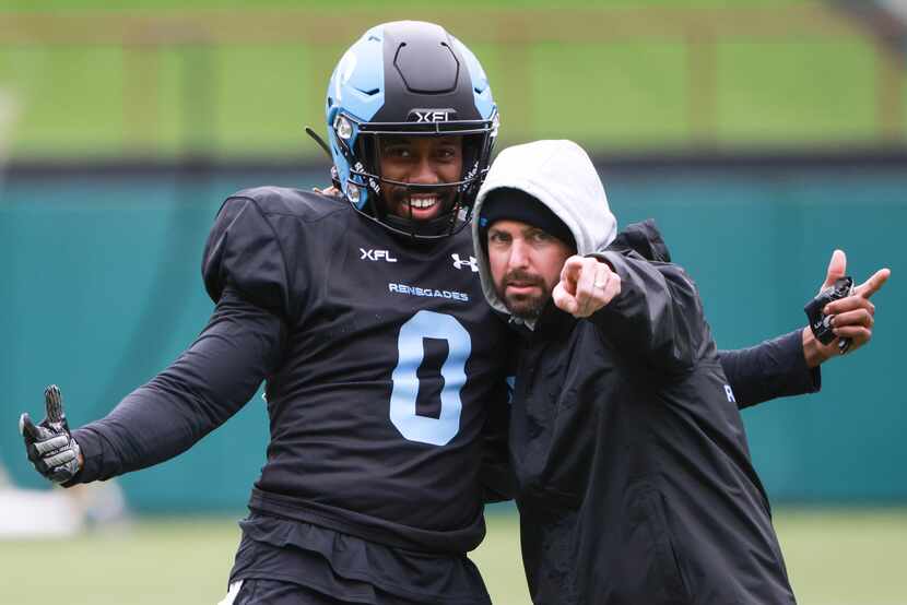 Arlington Renegades Marquette King (0) poses with an Arlington Renegades staff member for a...