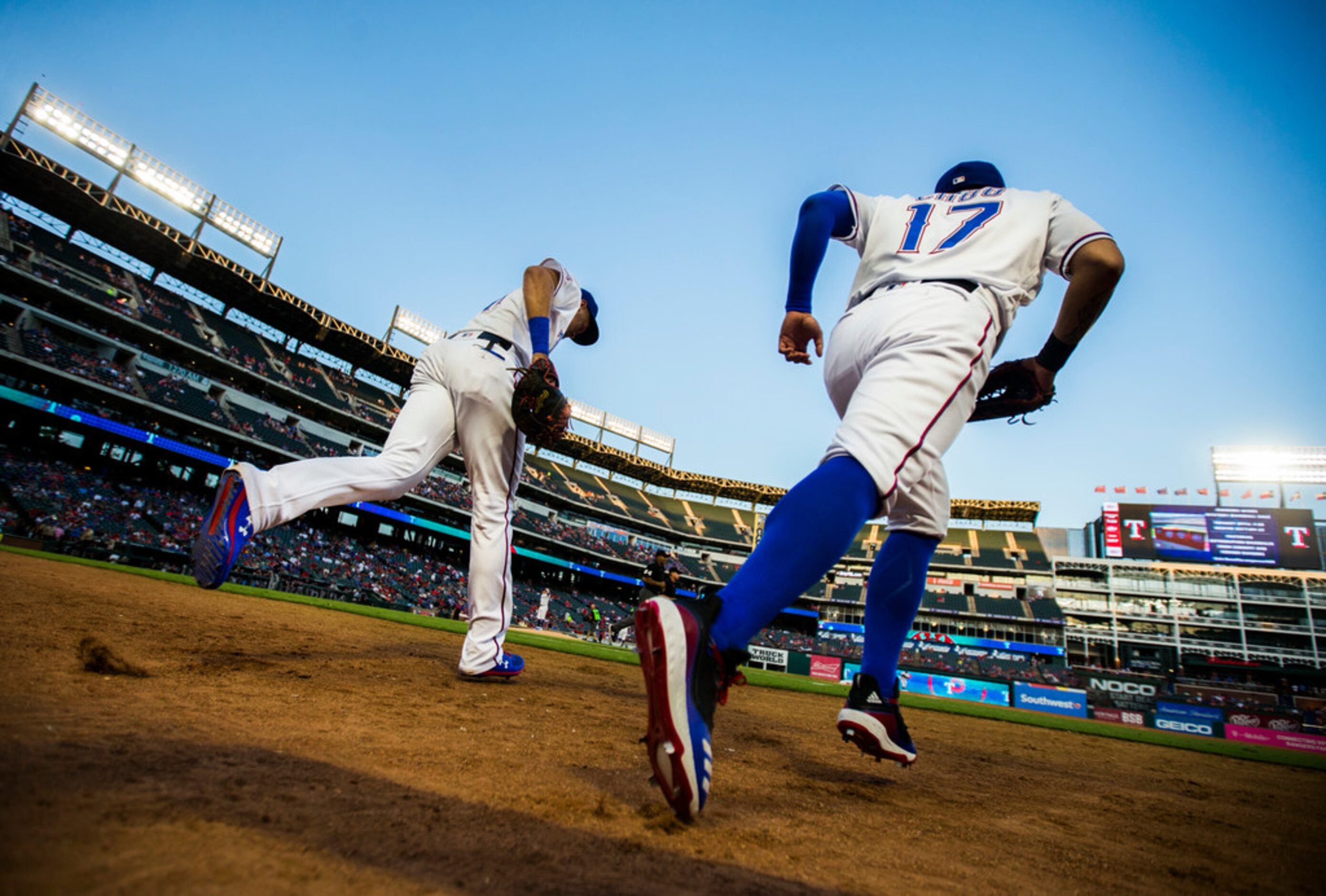 Texas Rangers first baseman Ronald Guzman (11) and right fielder Shin-Soo Choo (17) run on...