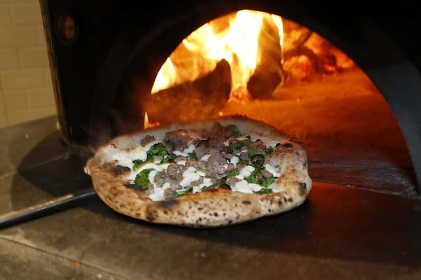 A salsiccia pizza comes out of the wood fired ovens at Pizzeria Testa in Frisco on Friday...