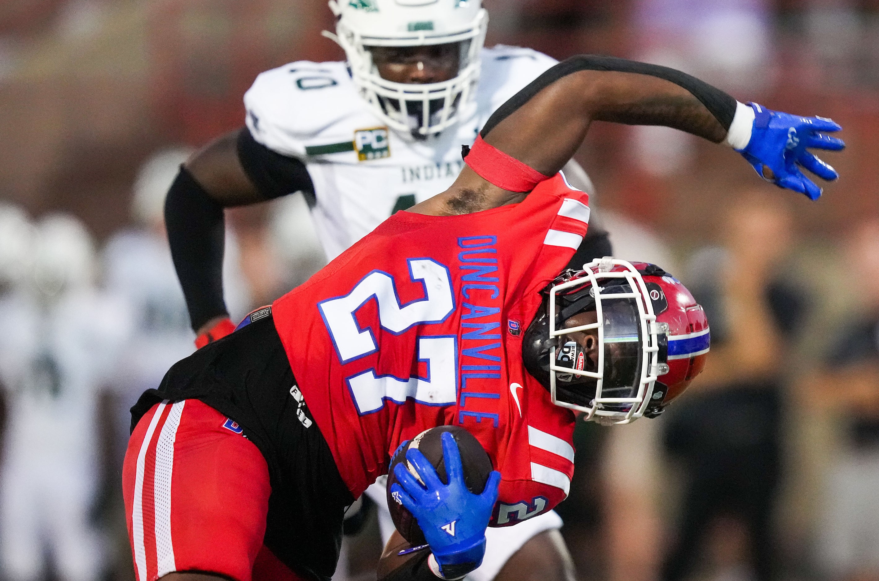 Duncanville running back JaQualon Armstrong (27) slips through the Waxahachie defense during...