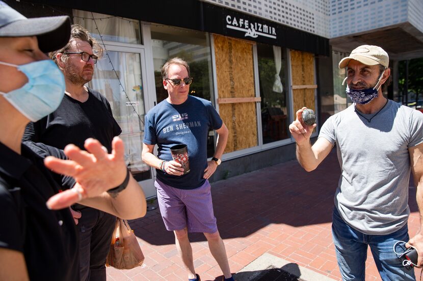 Cafe Izmir owner Beau Nazary shows Kourtney Garrett, President and CEO of Downtown Dallas...