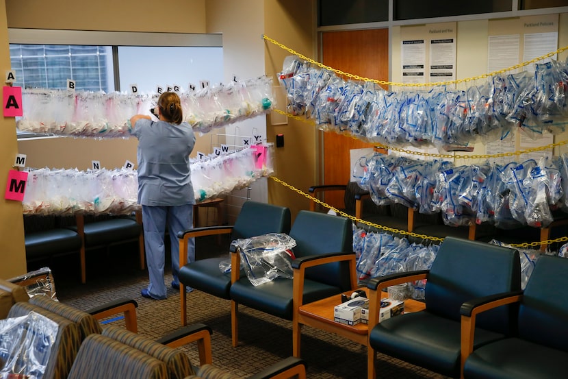 In a waiting room converted to a check-in station for the COVID-19 Tactical Care Unit,...