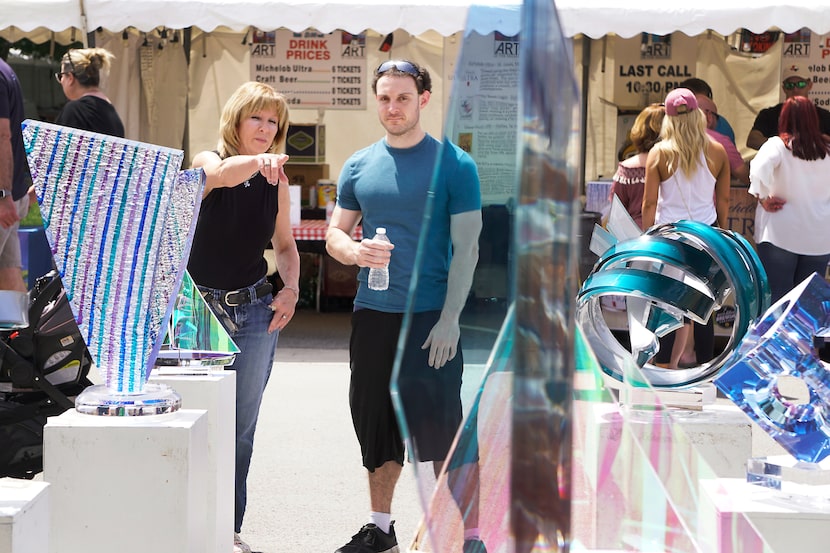 Christine Riggs and Brandon Allen browse through the works of visual artists at the 2018 Art...