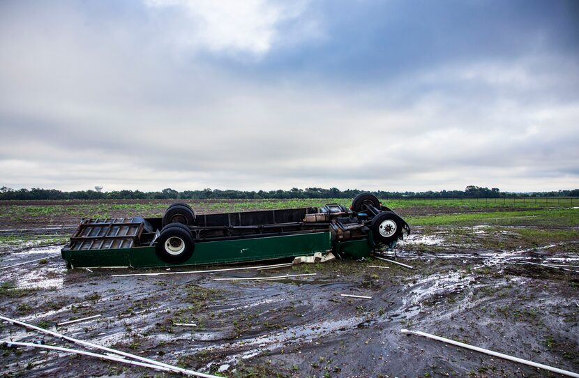 An overturn truck with "Spirit of Waxahachie Indian Band" written on the side sits in an...