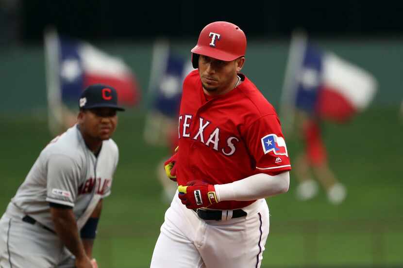ARLINGTON, TEXAS - JUNE 19:  Asdrubal Cabrera #14 of the Texas Rangers runs after hitting a...