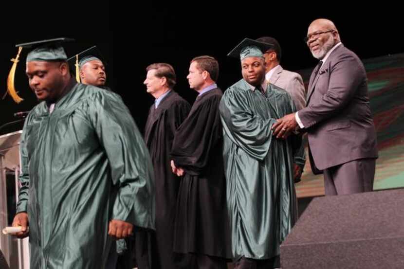 
Bishop T.D. Jakes (right) congratulates graduates of his Texas Offenders Re-entry...