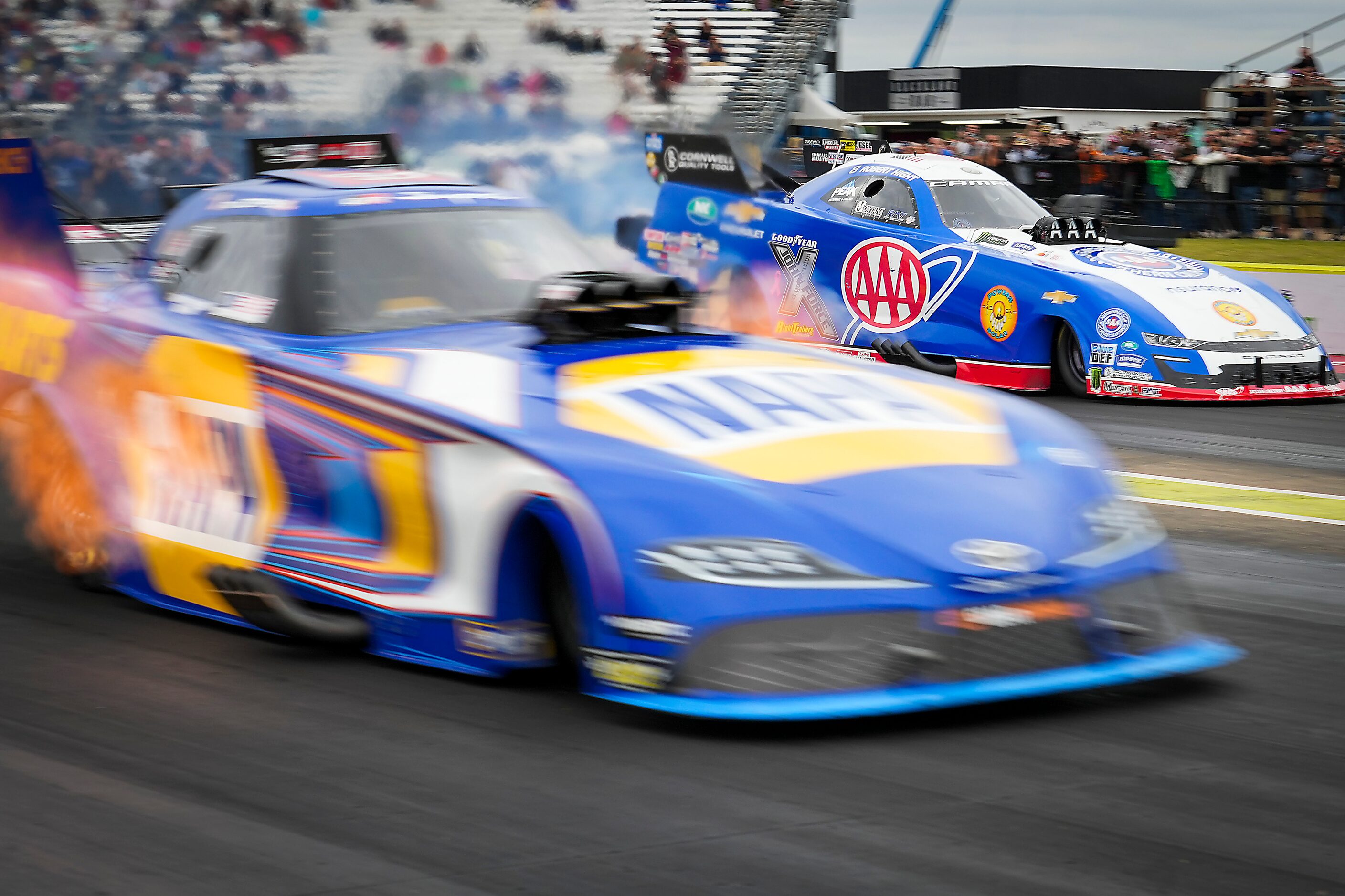 Ron Capps (front) beats Robert Hight off the line in a semifinal Funny Car victory at the...