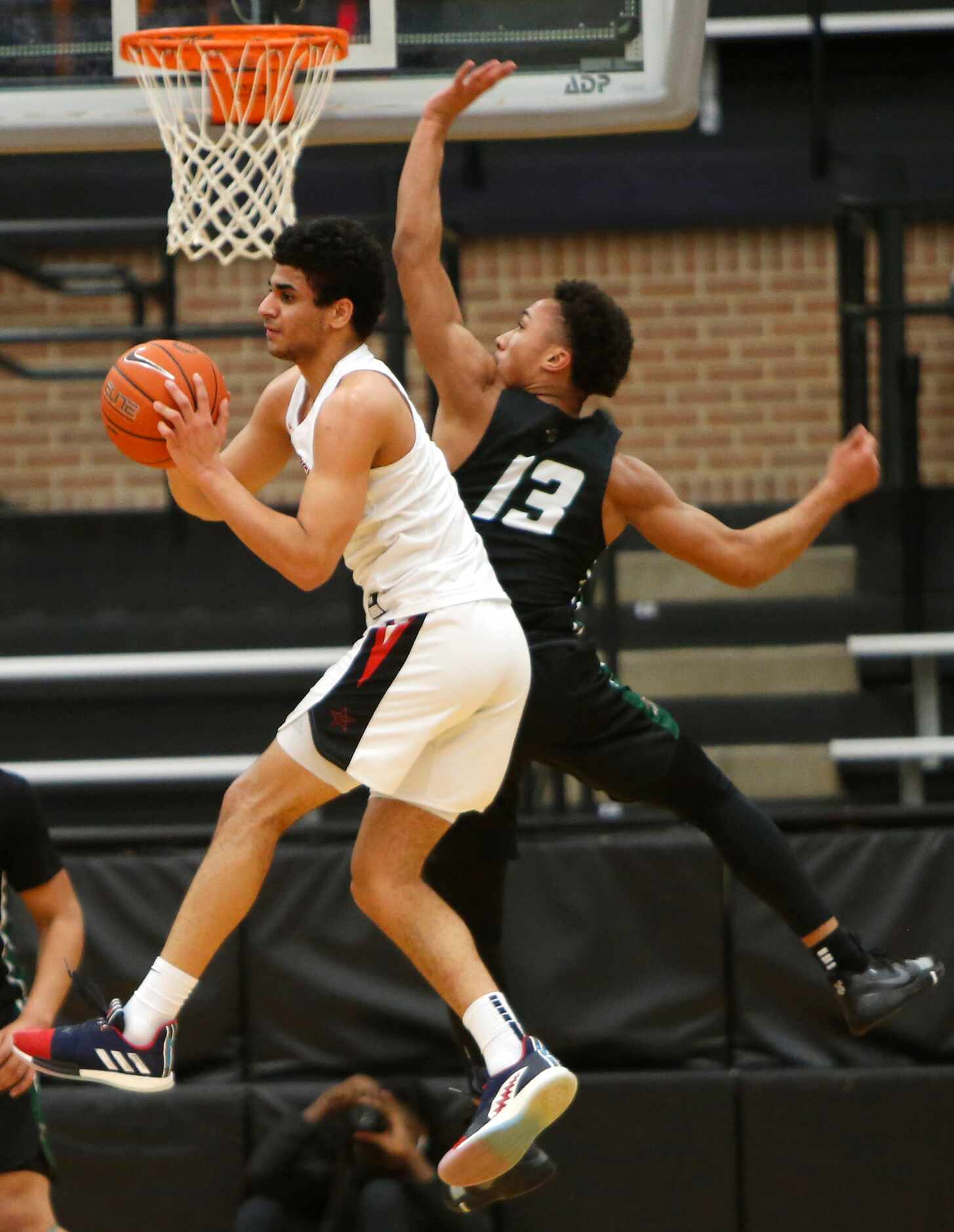 Coppell guard Adam Moussa (5) decides to pass after meeting the aggressive defense of...