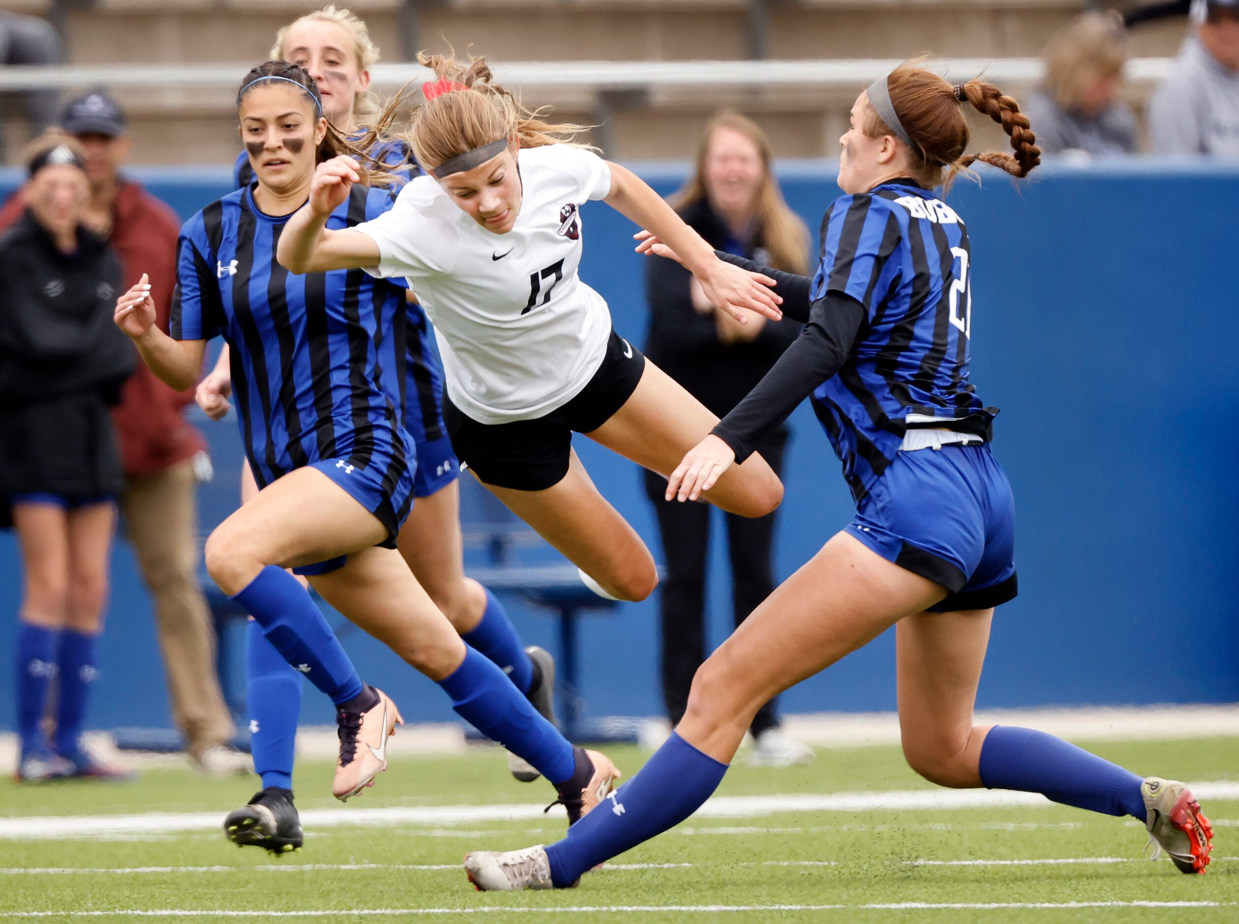 Flower Mound Marcus forward Madi Patterson (17) is sent flying after being tripped by Trophy...