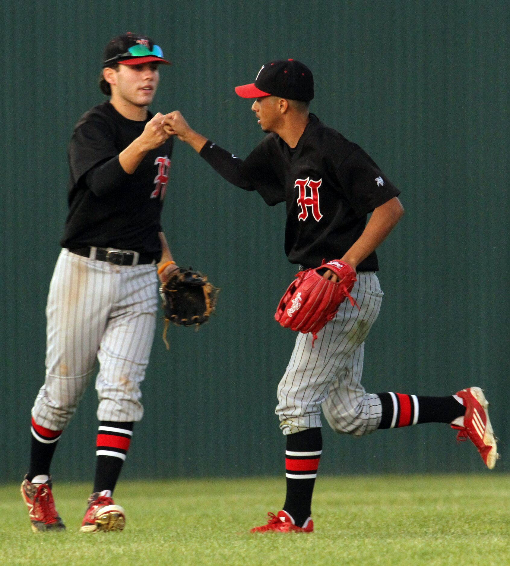 Dallas Hillcrest center fielder Taylor Ozarow (12), left, congratulates left fielder Miguel...