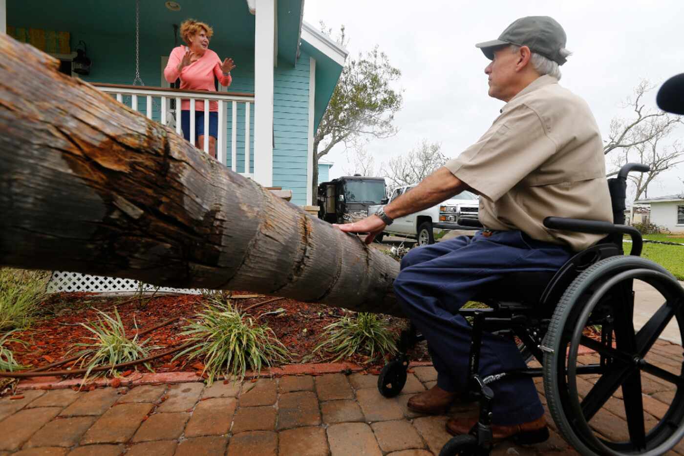 Marsha Brundett talks to Texas Gov. Greg Abbott about riding out the storm as he toured...