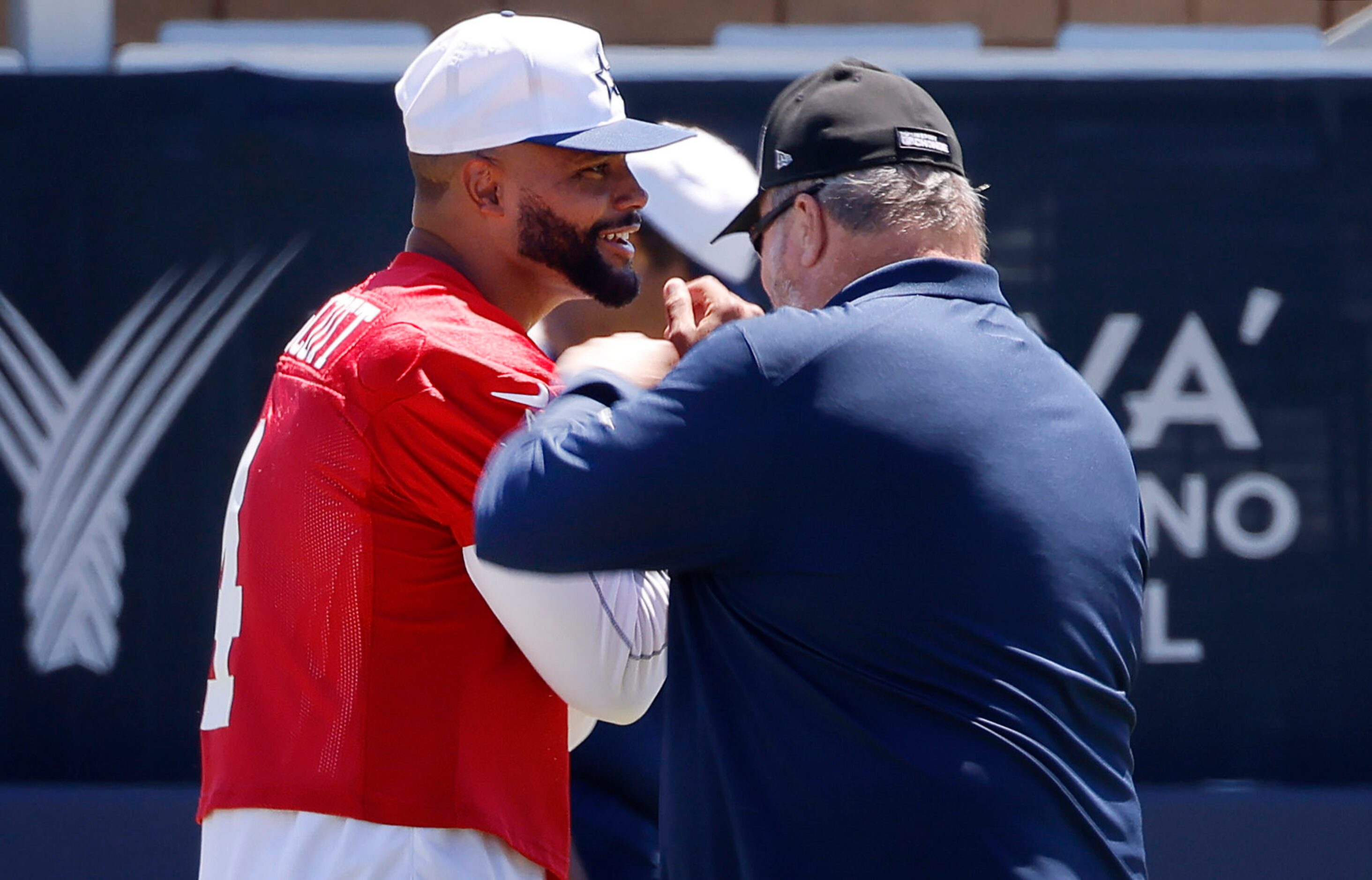 Dallas Cowboys head coach Mike McCarthy  playfully punches quarterback Dak Prescott ...