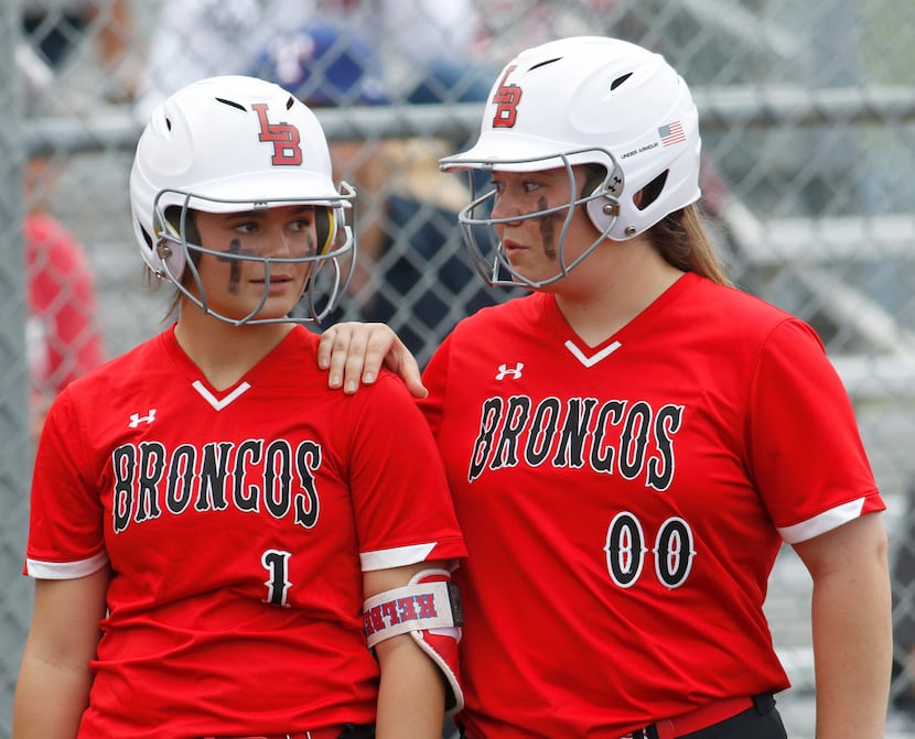 Mansfield Legacy infielders Kelby Robbins (1) and Katie Shoemaker (00) converse while the...