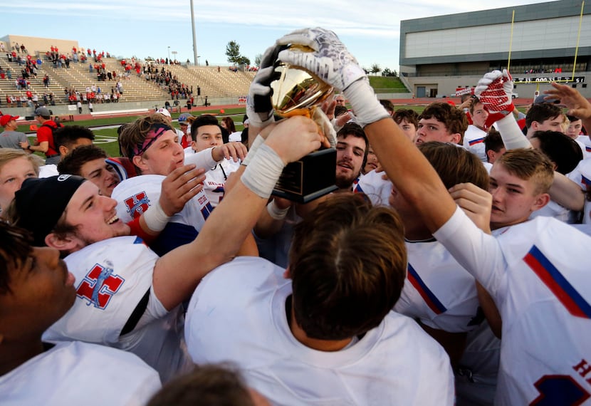 Midlothian Heritage get a hands-on experience on the game trophy, after the team's 51-20 win...