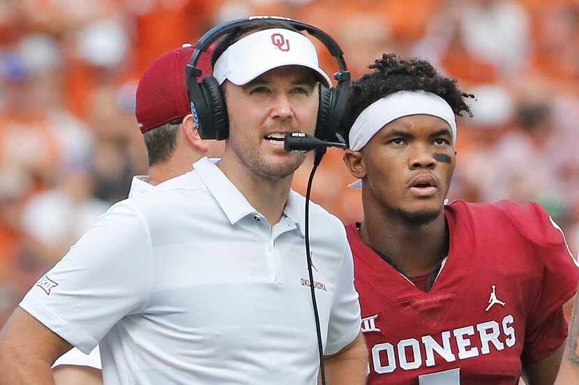 Oklahoma head coach Lincoln Riley and Oklahoma Sooners quarterback Kyler Murray (1) confer...