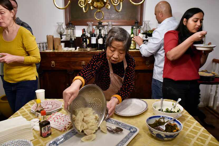 Zhen Hua, 78, serves a batch of freshly boiled pork dumplings during a Chinese New Year...