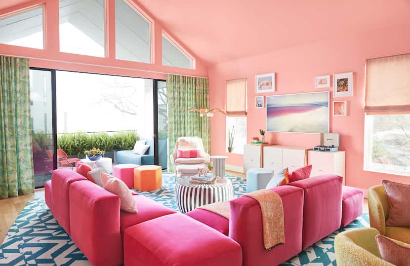 This vibrant Airbnb home, with walls covered in Benjamin Moore’s “Dawn Pink,” is a...