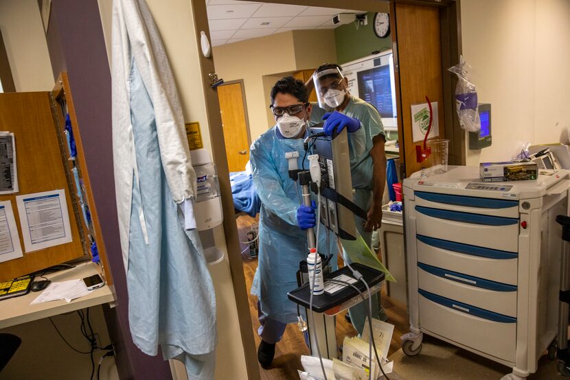 Certified registered nurse anesthetist Steven Vela (left) rushed from helping one COVID-19...