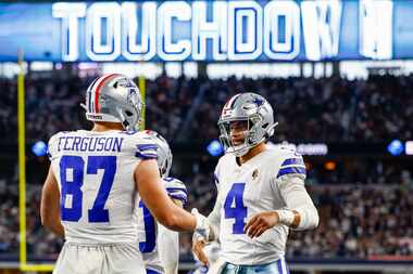Dallas Cowboys quarterback Dak Prescott (4) congratulates tight end Jake Ferguson (87) on...