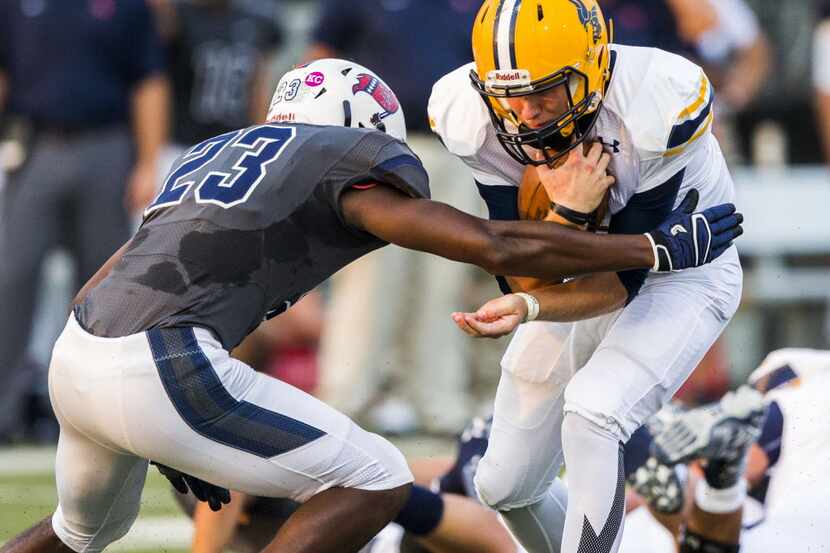 Arlington Lamar High School quarterback Shane Buechele (7) is tackled by Richland High...