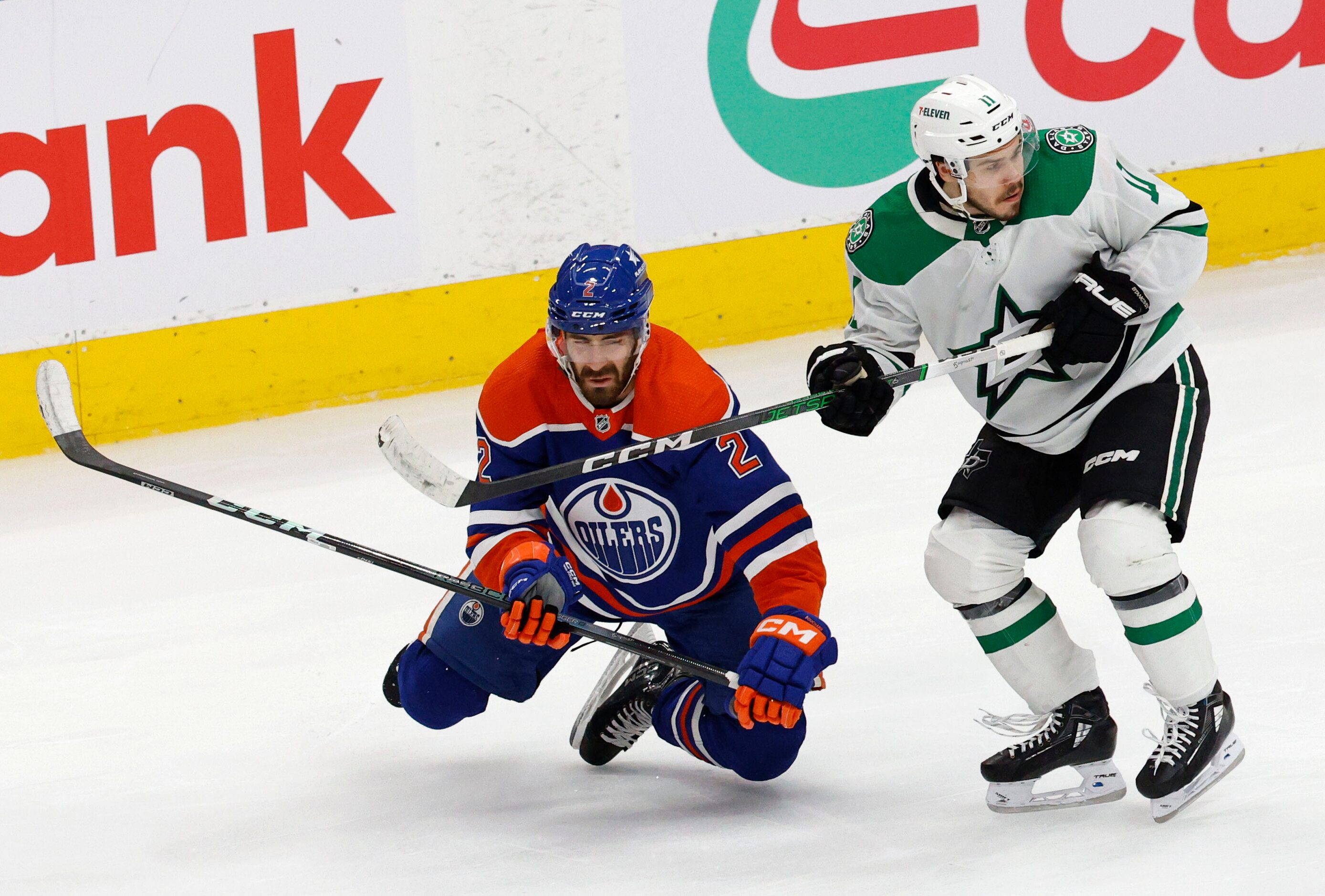 Edmonton Oilers defenseman Evan Bouchard (2) loses his balance as he skates against Dallas...