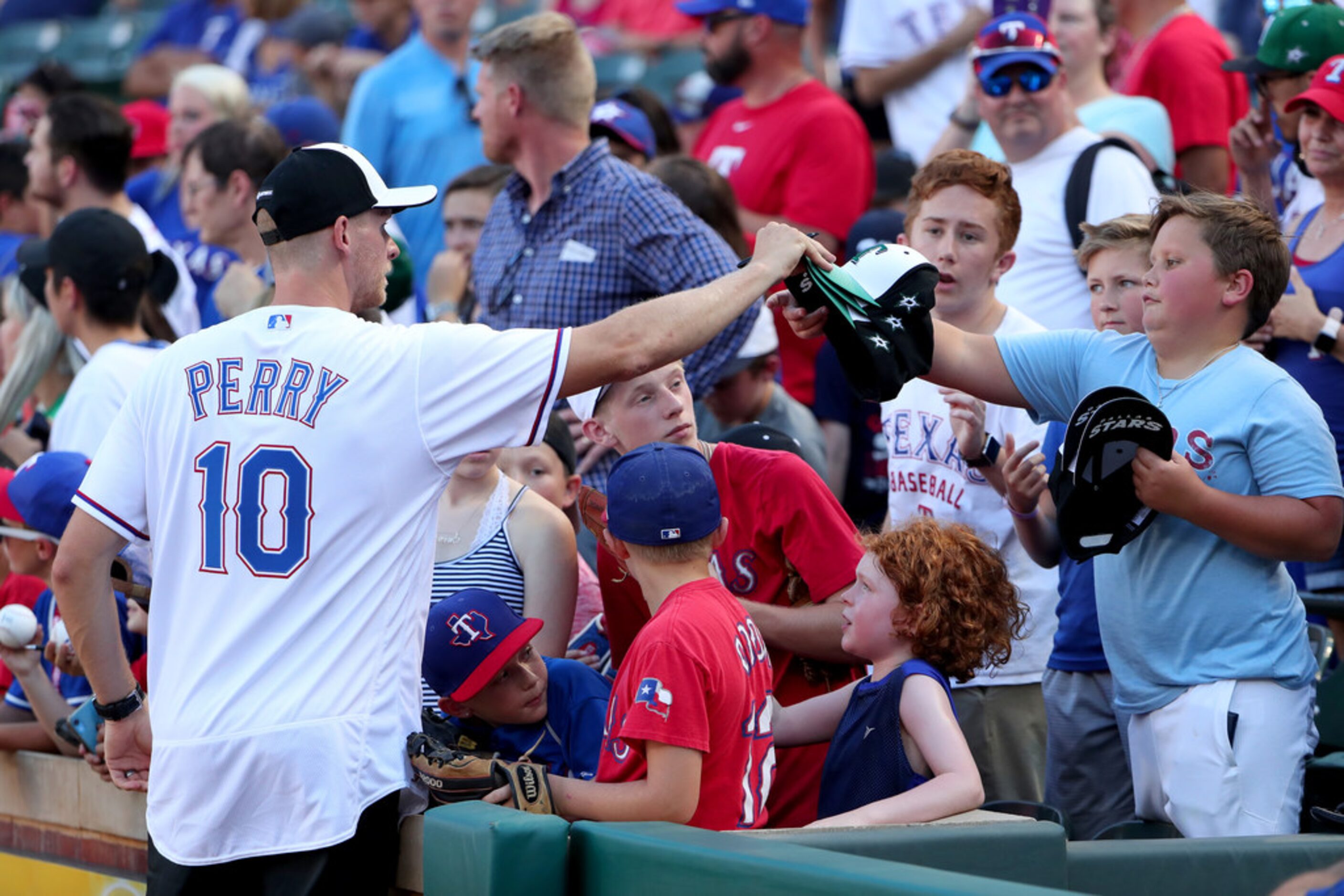 ARLINGTON, TEXAS - JULY 17: Corey Perry of the Dallas Stars signs autographs for fans before...