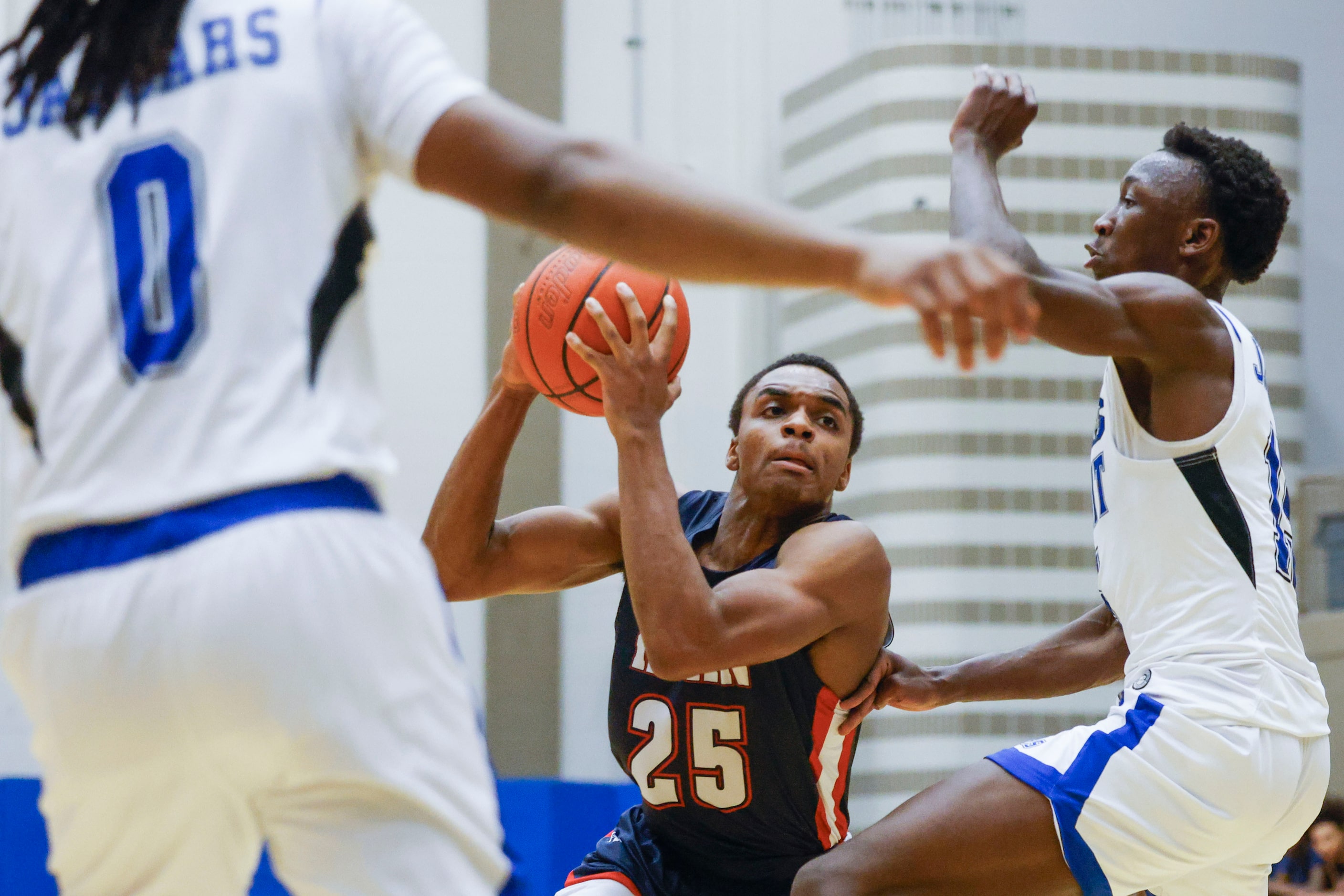 Denton Ryan’s Scottie Johnson (25) looks to dribble past Mansfield Summit’s Derrick Brown...