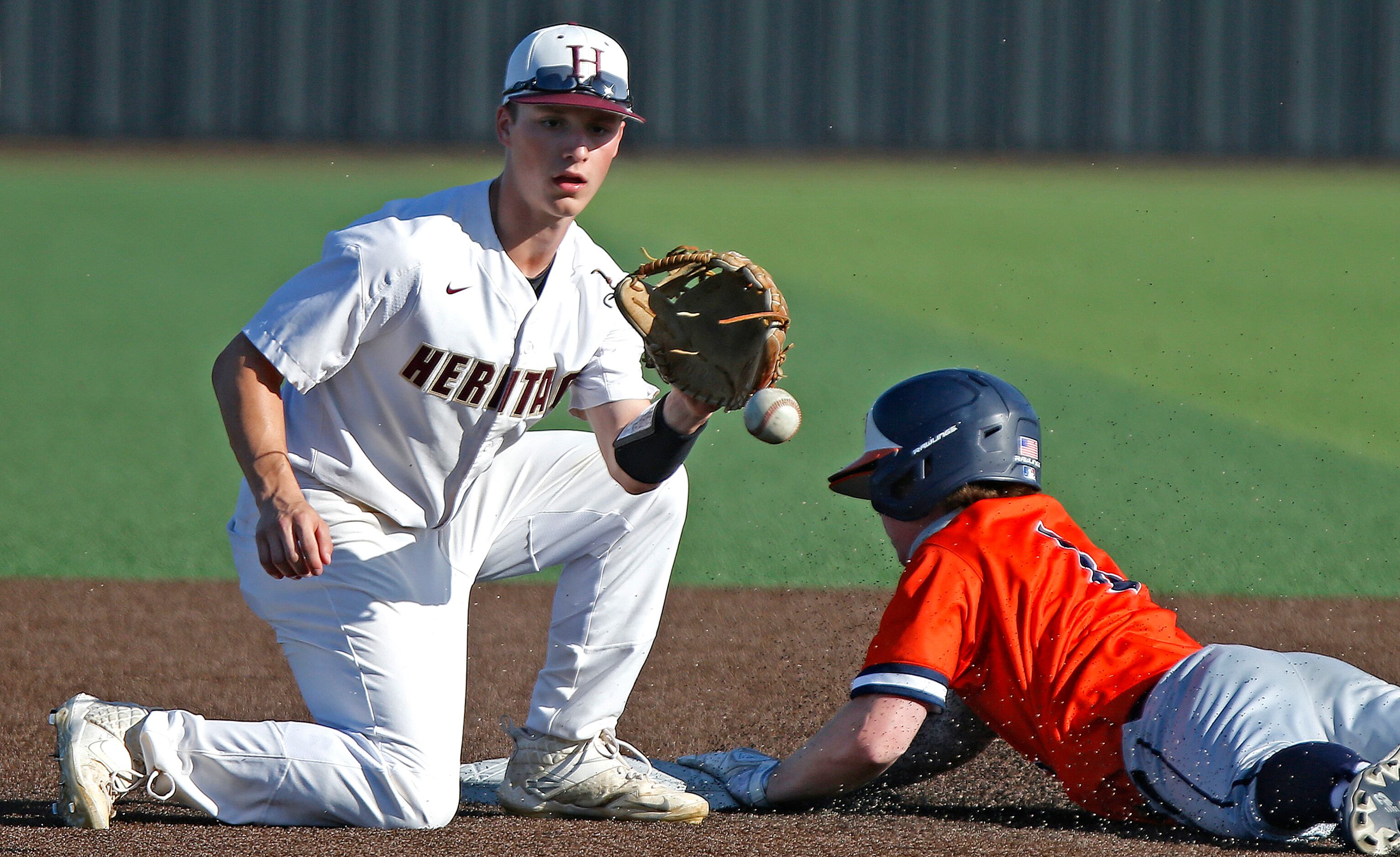 Heritage shortstop Mason Wilson (2) wsn’t able to get the tag on as Wakeland shortstop Conor...