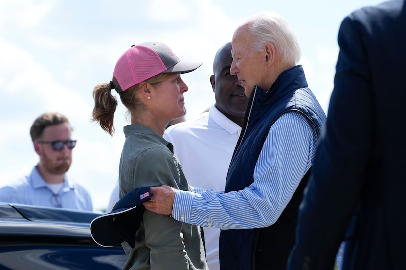 President Joe Biden talks with Asheville Mayor Esther Manheimer after arriving at...