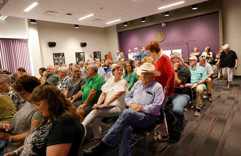 People wait for a special board meeting to start in Granbury Independent School District,...