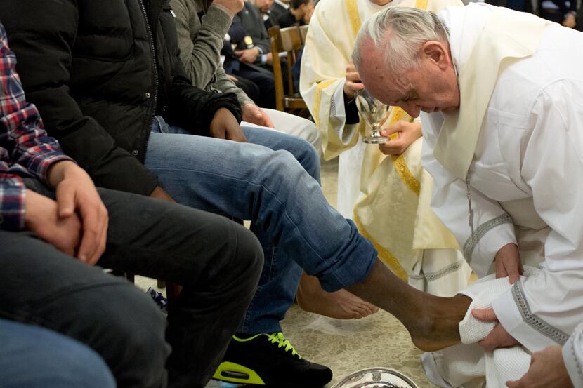 In this photo provided by the Vatican newspaper L'Osservatore Romano, Pope Francis washes...