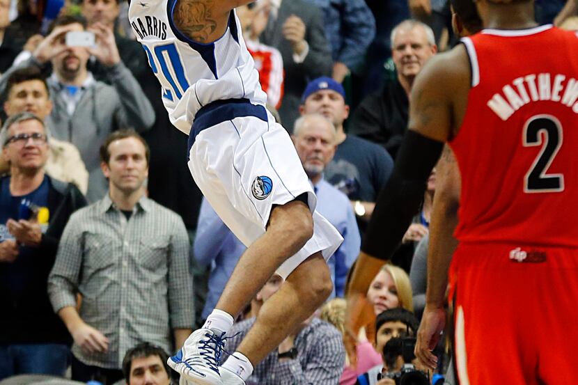 Dallas Mavericks point guard Devin Harris (20) is puts up a running jumper to put the...