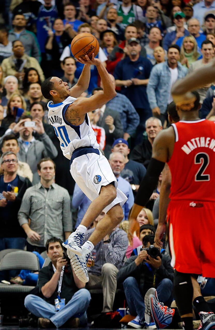 Dallas Mavericks point guard Devin Harris (20) is puts up a running jumper to put the...