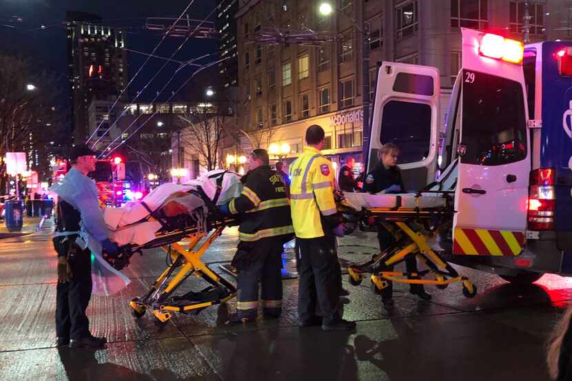 SEATTLE, WA - JANUARY 22: EMT and Police give first aid to a shooting victim in downtown on...