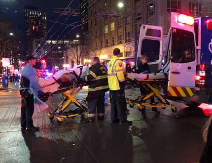 SEATTLE, WA - EMT and Police give first aid to a shooting victim in downtown on Wednesday in...