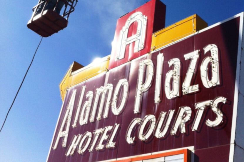 A crew began removing the sign at the former site of Alamo Plaza Hotel Courts in April.