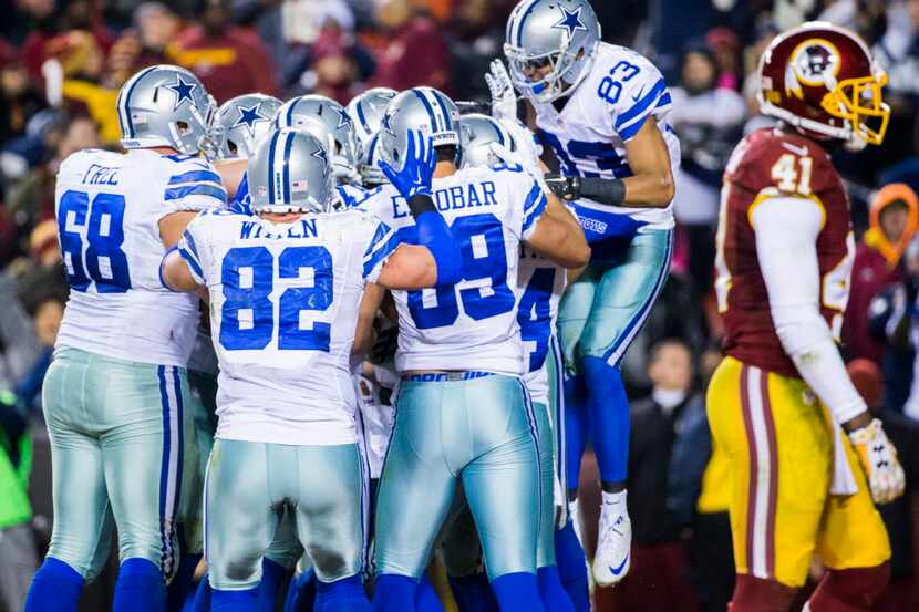 The Dallas Cowboys celebrate after scoring a touchdown during the fourth quarter of their...