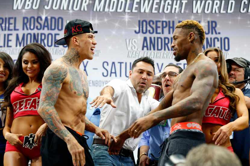 Boxer Gabriel Rosado (left) shoves Willie Monroe, Jr. as promoter Oscar De La Hoya separates...