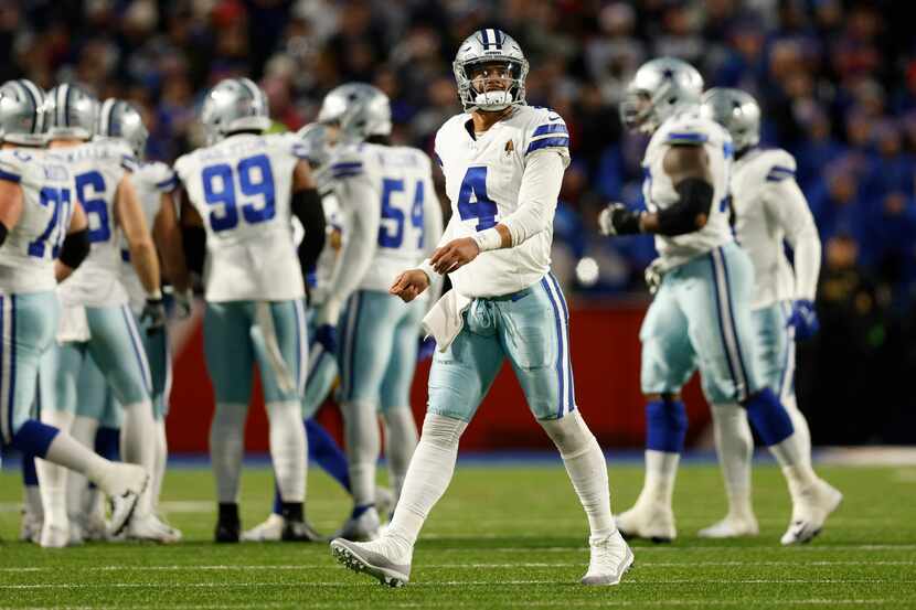Dallas Cowboys quarterback Dak Prescott (4) watches a replay on the video board after a sack...