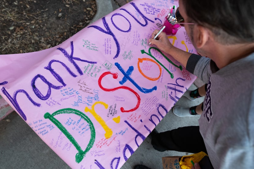 Business owner Michael Bahr signed a thank-you poster for outgoing Richardson ISD...