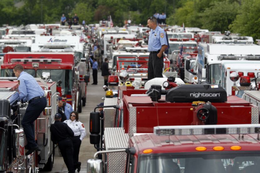 Firefighters and trucks gathered in a staging area recently in West before a procession to...