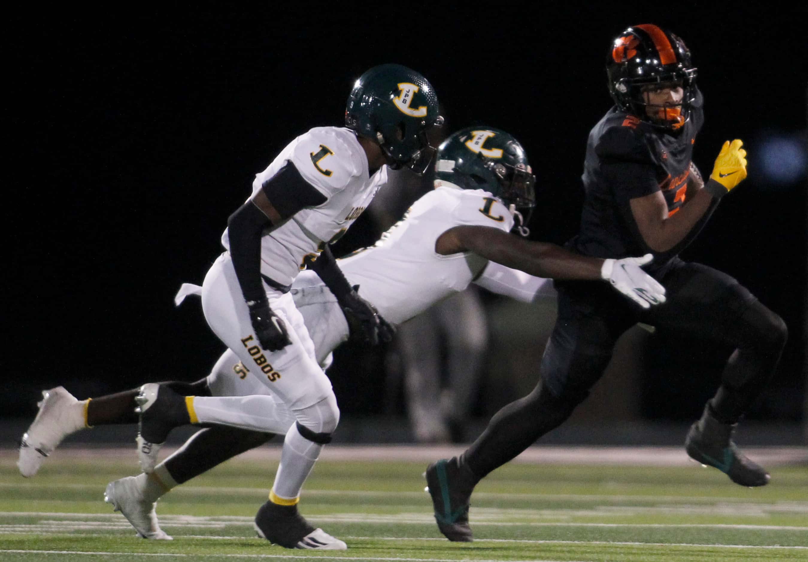 Lancaster running back Kewan Lacy (2), right, pulls away from the defensive pursuit of a...