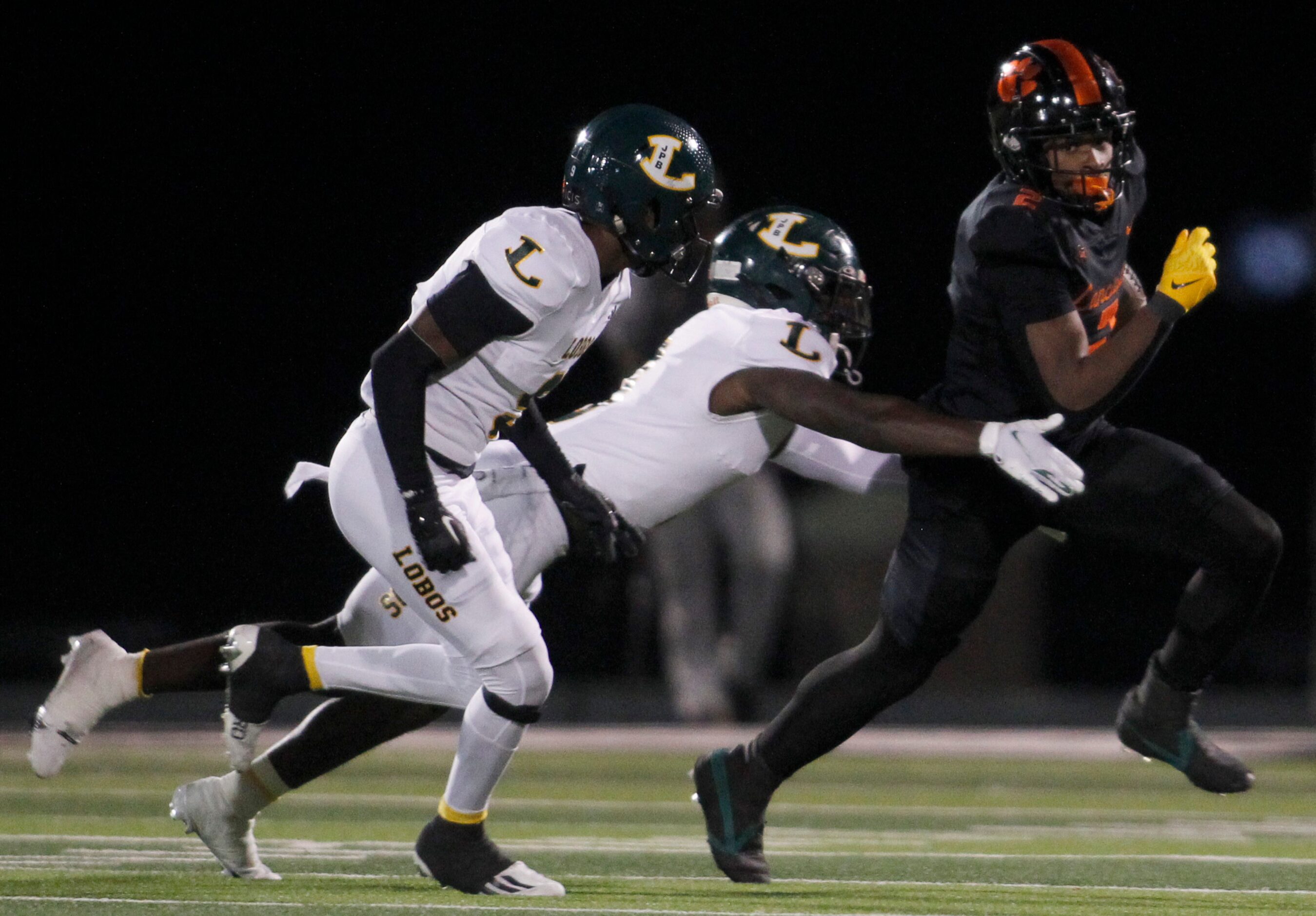 Lancaster running back Kewan Lacy (2), right, pulls away from the defensive pursuit of a...