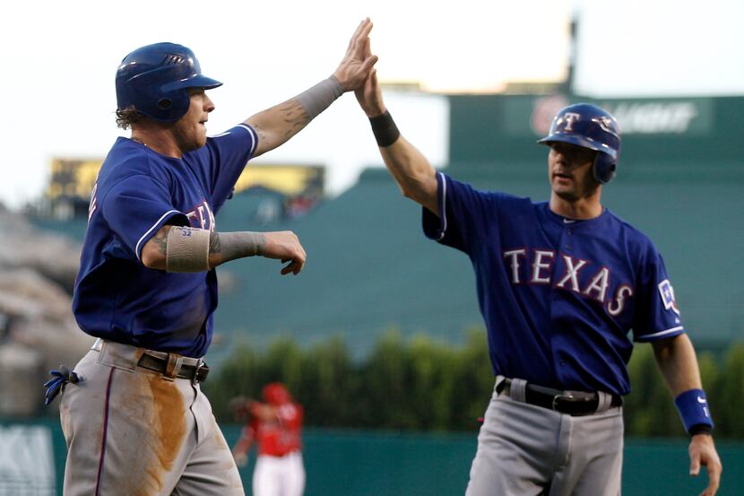 ORG XMIT: ANS108 Texas Rangers' Josh Hamilton, left, and Michael Young celebrate after...