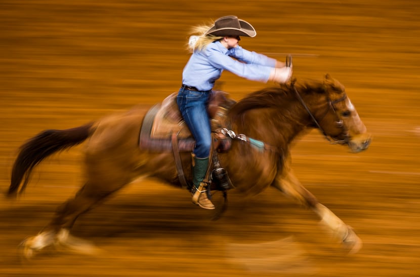A member of the RA Brown Ranch team competes in Ranch Girl's Barrel Race during a "Best of...