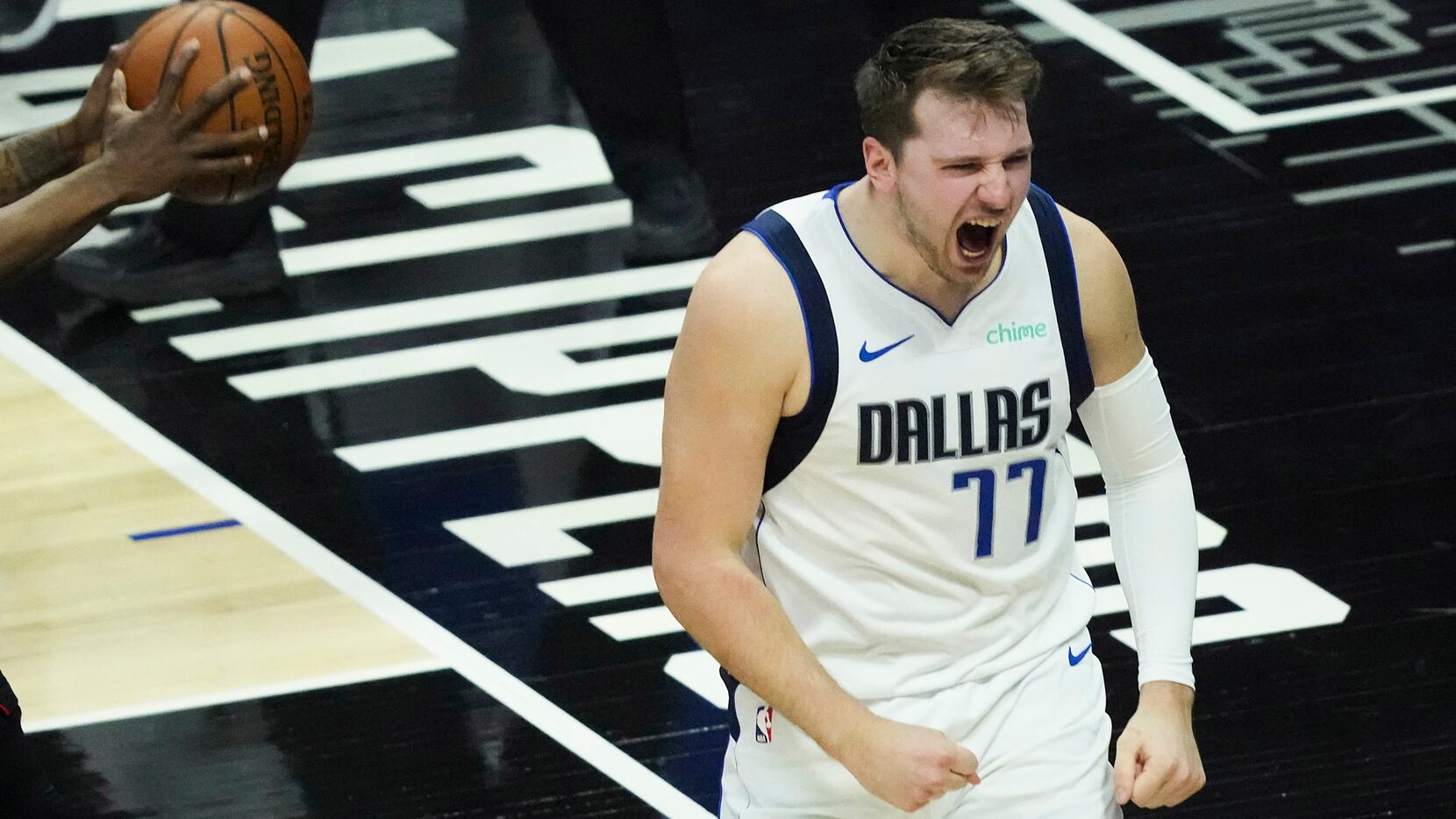Dallas Mavericks guard Luka Doncic (77) reacts after picking up a basket and a foul against...