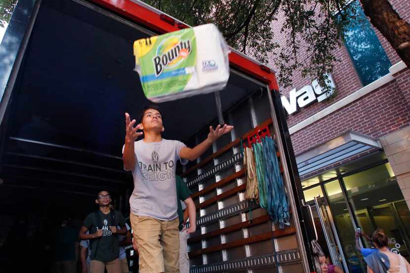Ruben Fuentes, 15, and his soccer teammates from Waxahachie High School helped load...