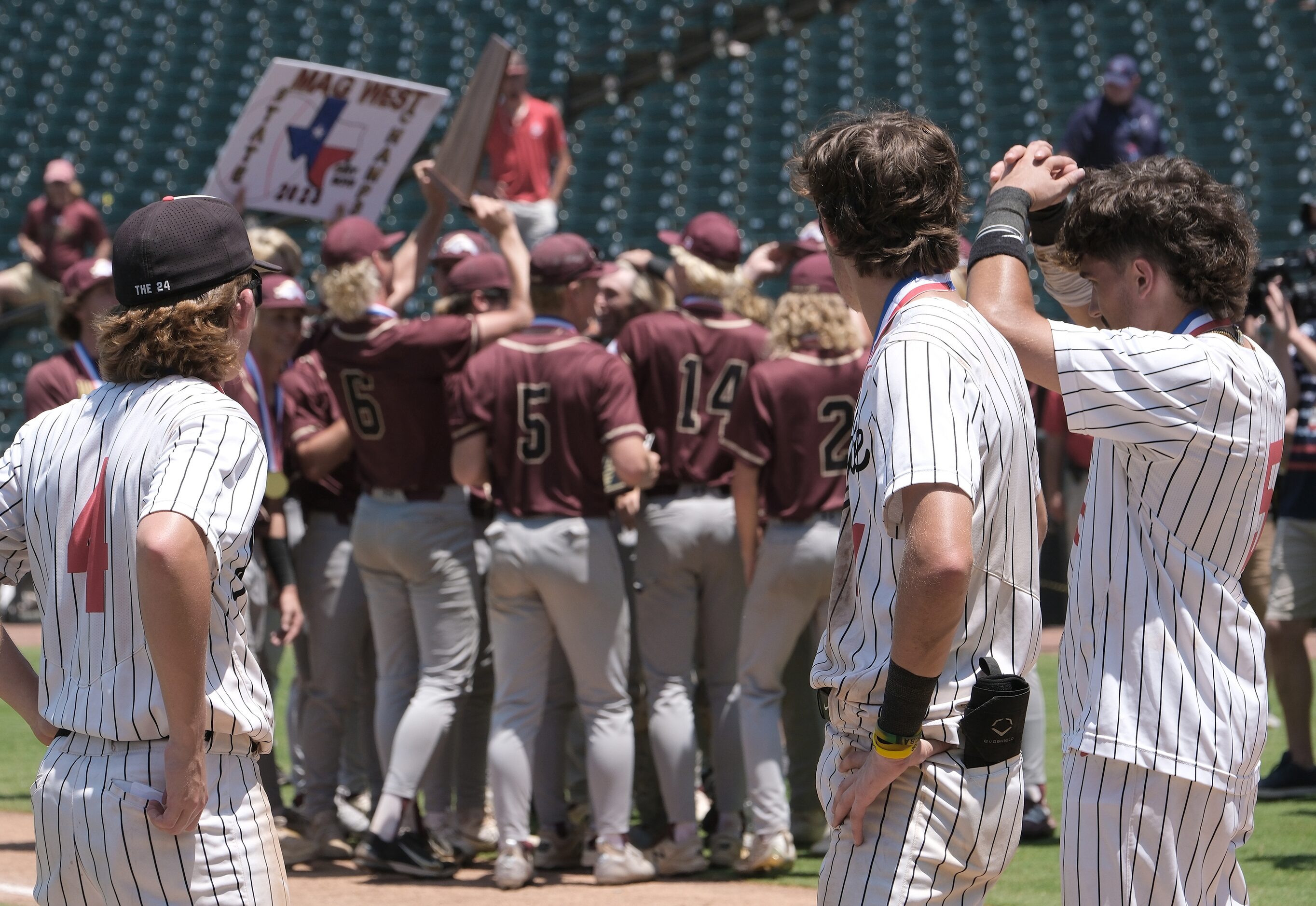 Argyle JC Davis, (4), Grady Emerson, (1), and Colton Roquemore, (5), look on as Magnolia...