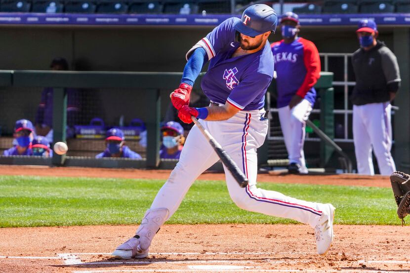 Texas Rangers outfielder Joey Gallo hits a solo home run during the first inning of a spring...
